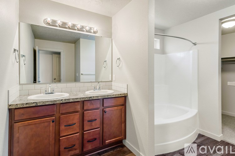 A bathroom with a vanity and a bathtub.