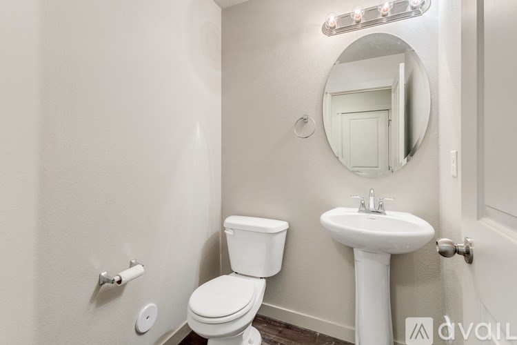 A white toilet and sink in a small bathroom.