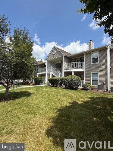 A large house with a tree in front of it.