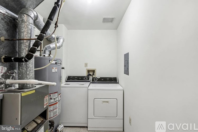 A small room with a washing machine and a dryer.