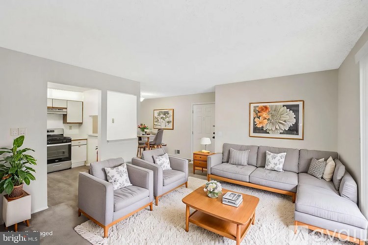 A living room with grey couches and a wooden coffee table.