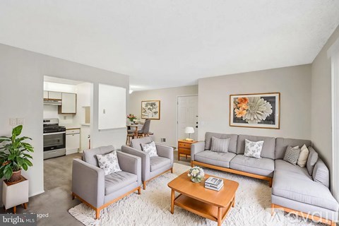 A living room with grey couches and a wooden coffee table.