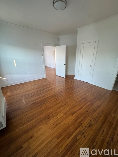 A room with wooden floors and white walls.
