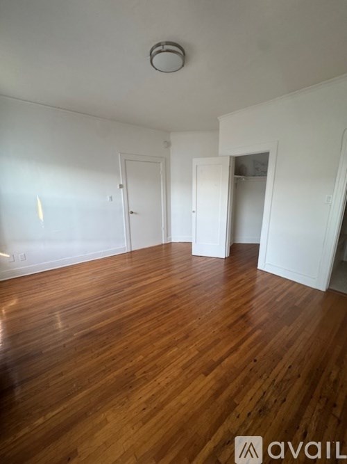 A room with wooden floors and white walls.