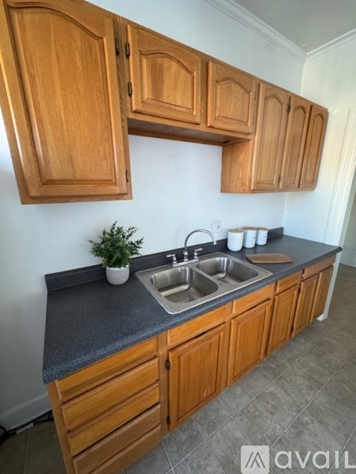 A kitchen with wooden cabinets and a grey countertop.