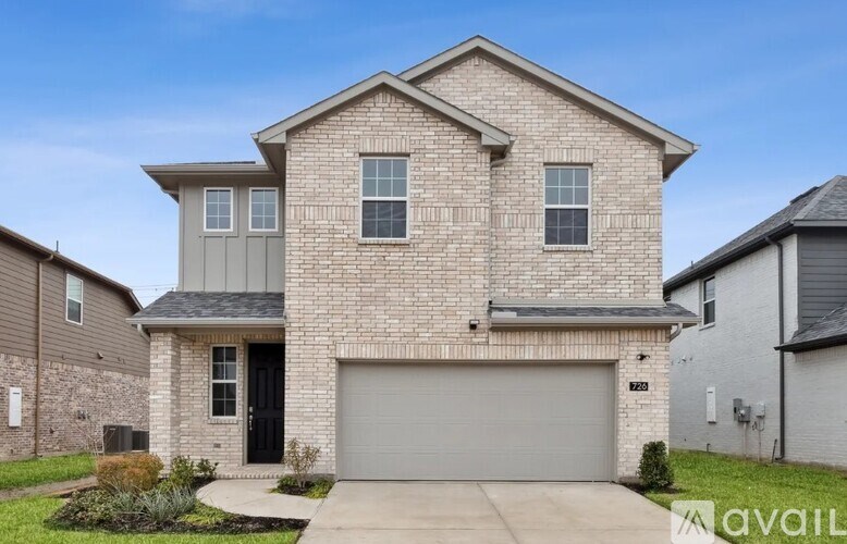 A two-story house with a garage is available for sale.