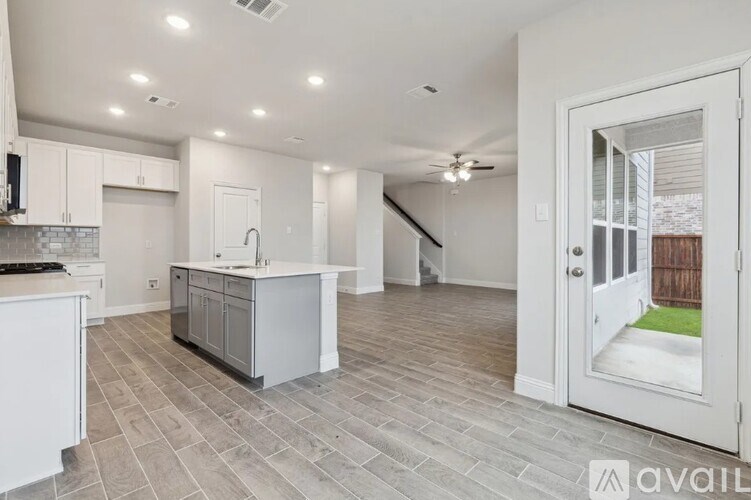A kitchen with a white countertop and a grey floor.