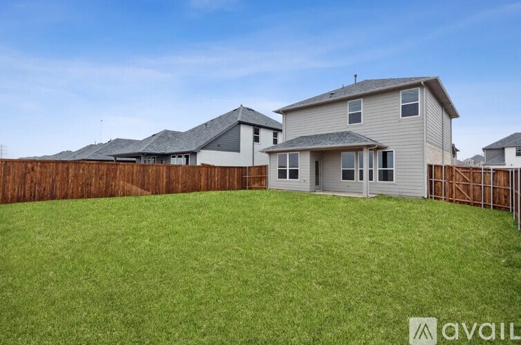 A house with a fence and a grassy yard is available for sale.