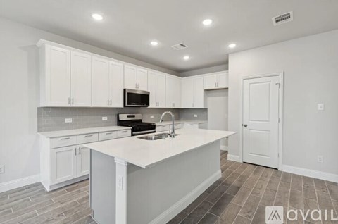 A kitchen with white cabinets and a central island.