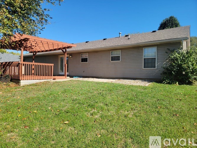 A house with a brown roof and a covered patio.
