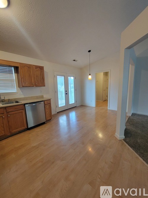 A kitchen with wooden cabinets and a dishwasher.