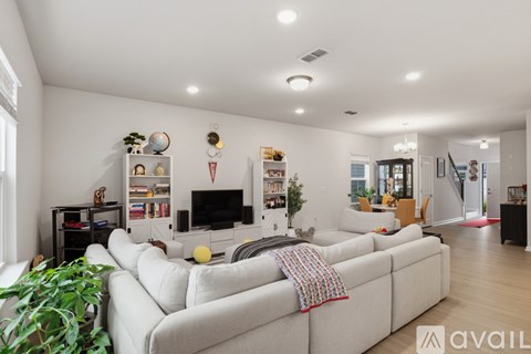 A living room with a large couch and a television.