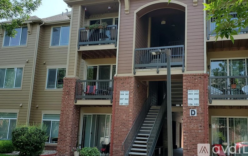 Apartment complex with a staircase leading to the second floor.
