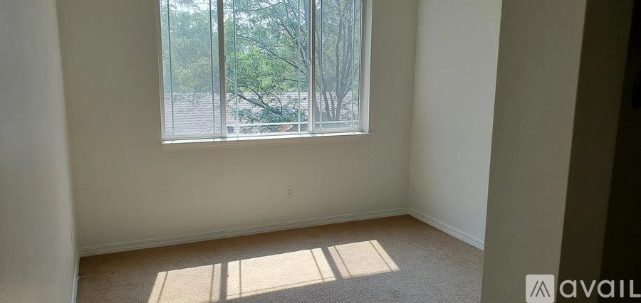 A room with a window and sunlight coming through.