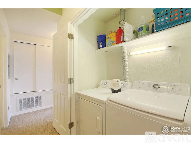 A small laundry room with a washer and dryer.