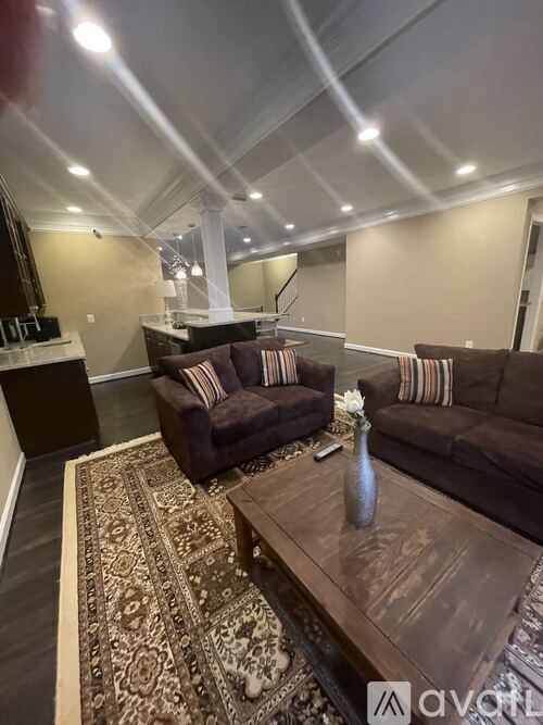 A living room with a brown couch and a coffee table.