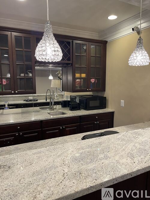 A kitchen with granite countertops and a microwave.