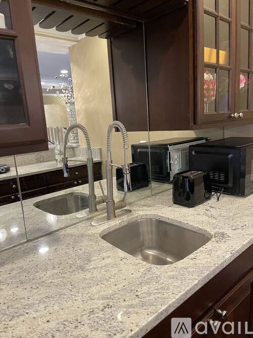A kitchen with a granite countertop and a sink.