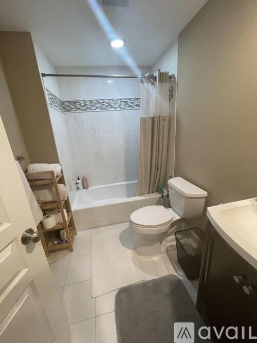 A bathroom with a toilet, sink, and bathtub.