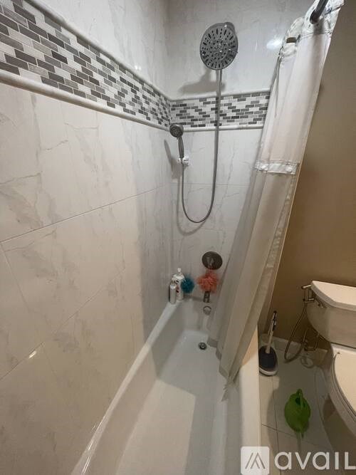 A bathroom with a shower, tub, and toilet.