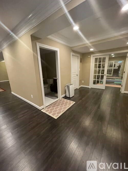 A room with wooden floors and a white door.