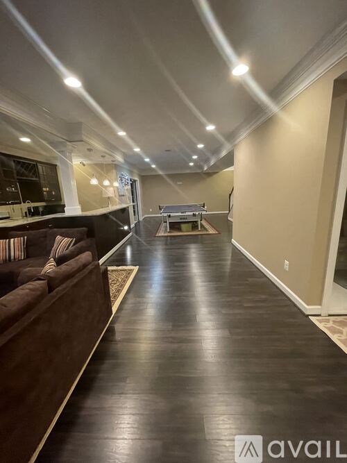 A long hallway with a couch and a coffee table.