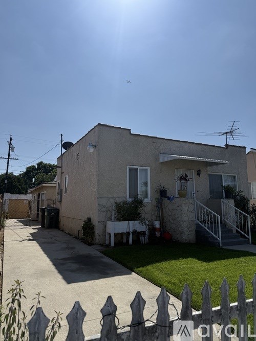 A house with a white picket fence in front.