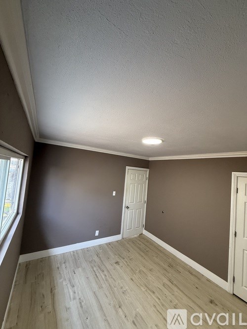 A room with a brown wall and a white door.