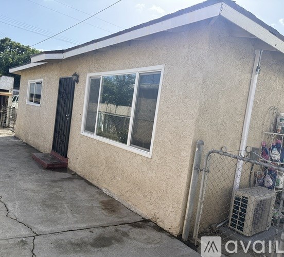 A house with a black gate and a window with a white frame.