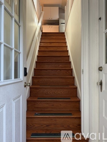 A staircase with a white door on the right.