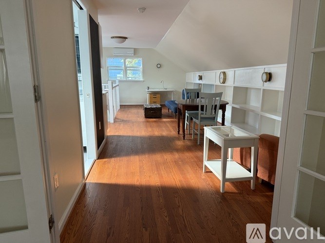 A room with wooden floors and white walls.