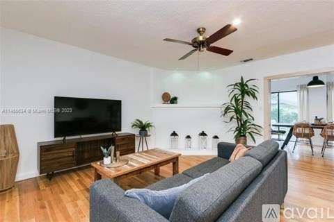 A living room with a grey couch and a flat screen TV.