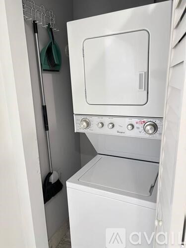 A white oven with a door and a handle is in a kitchen.