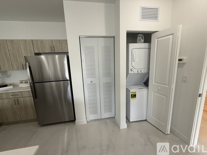 A kitchen with a stainless steel refrigerator and a white refrigerator freezer.