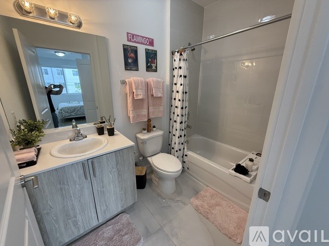 A bathroom with a sink, toilet, and shower.