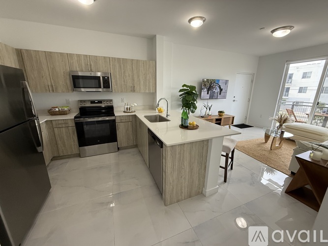 A kitchen with a refrigerator, stove, and sink.