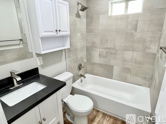 A white toilet sits next to a sink in a bathroom.