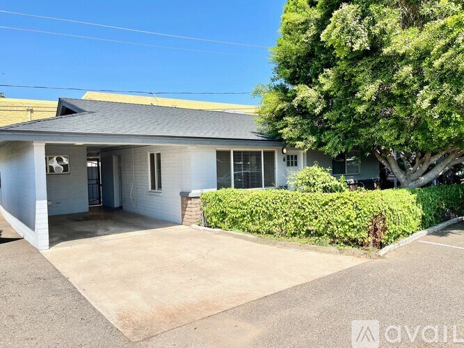 A house with a grey roof and a white garage door.