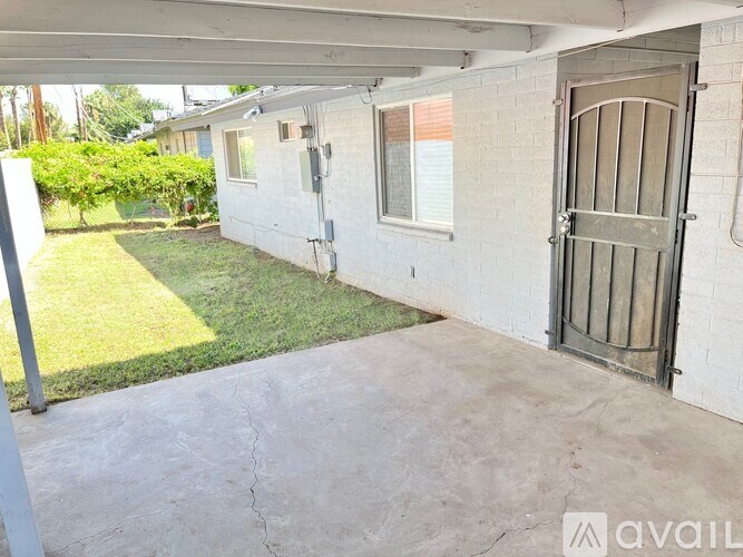 A white house with a closed metal gate.