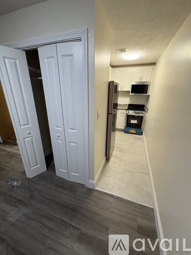 A kitchen area with a refrigerator, oven, and microwave.