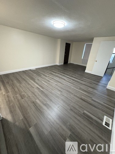 A room with wooden flooring and a light on the ceiling.