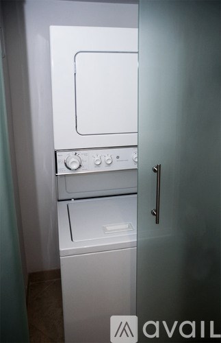 A white oven and stove top are in a small kitchen.