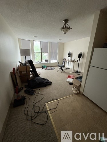 A room with a lot of clutter and a chandelier hanging from the ceiling.