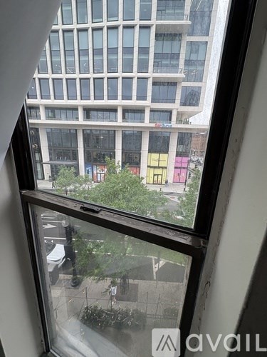 A view from a window looking out at a city street.