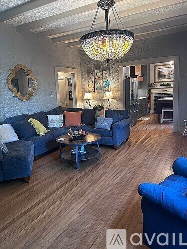 A living room with a blue couch and a coffee table.