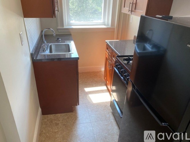 A kitchen with a sink, stove, and oven.