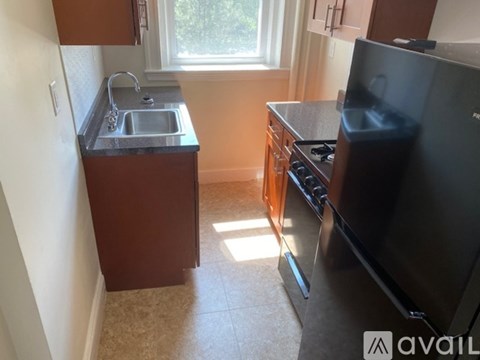A kitchen with a sink, stove, and oven.