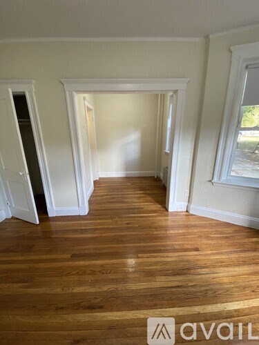 A room with wooden floors and white walls.