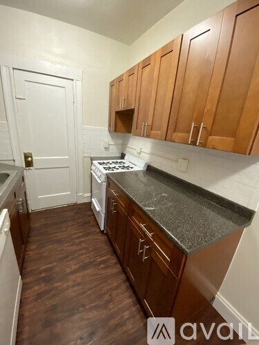 A kitchen with wooden cabinets and a white door.