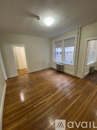 A room with wooden floors and white walls.